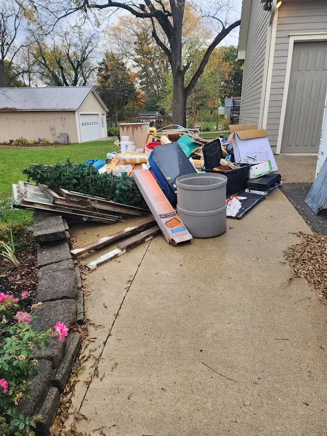 Dumpster being loaded with debris for Roofing Dumpster Rental in Milwaukee